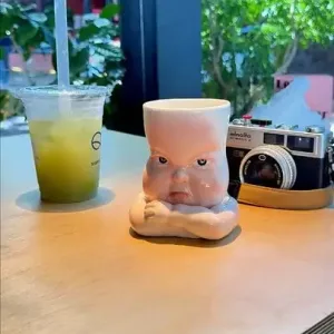 Whimsical Ceramic Pouty Mug-this hand-painted mug features a quirky pouting expression with twisted lips