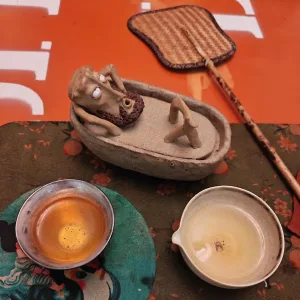 Bathing Zen Monk Clay Figurine-This handmade clay incense burner features a lounging monk blowing smoke from his mouth with an exaggerated, unbothered expression.