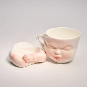 Whimsical Ceramic Cheeky Pull Mug-this hand-painted mug captures a playful moment with the mouth corner being pulled