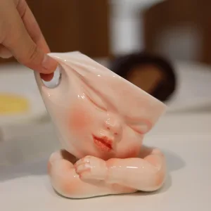 Whimsical Ceramic Cheeky Pull Mug-this hand-painted mug captures a playful moment with the mouth corner being pulled