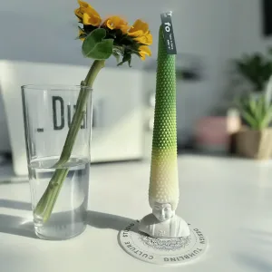 Whimsical Buddha Head Scented Candle-Featuring an exaggerated wax "hair" that extends from a joyful Buddha base.