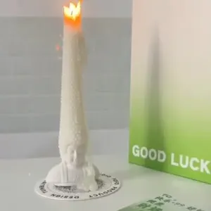 Whimsical Buddha Head Scented Candle-Featuring an exaggerated wax "hair" that extends from a joyful Buddha base.