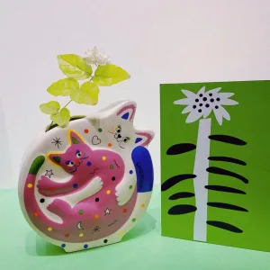 Hugging Cats Vase-A playful ceramic vase featuring two hugging cats covered in colorful doodles