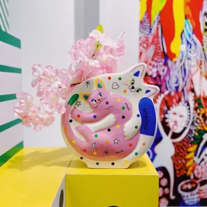 Hugging Cats Vase-A playful ceramic vase featuring two hugging cats covered in colorful doodles